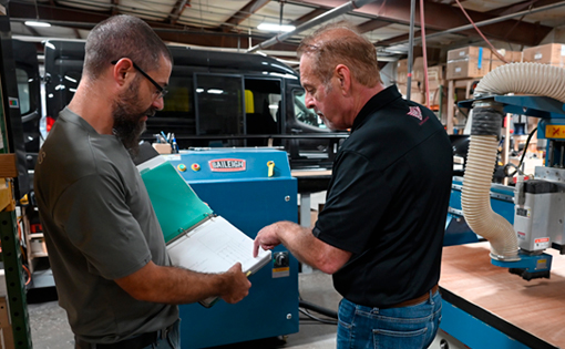 L.A. West’s CNC Operator Jordan Willsey (left) discussing files with President & CEO Vern Kauffman